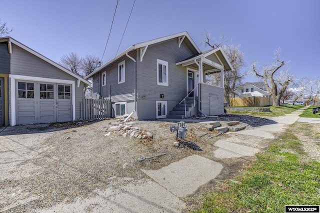 view of front facade featuring a garage and fence