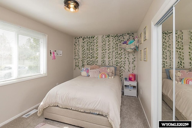 bedroom with carpet flooring, baseboards, and visible vents