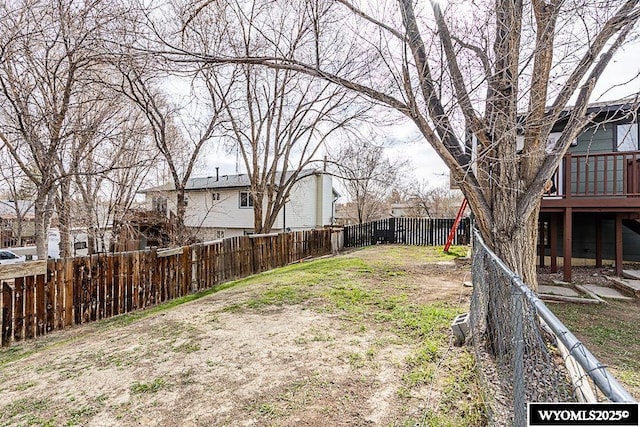 view of yard with a wooden deck and a fenced backyard