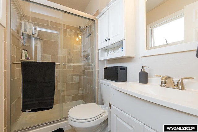 full bath with toilet, a shower stall, and vanity