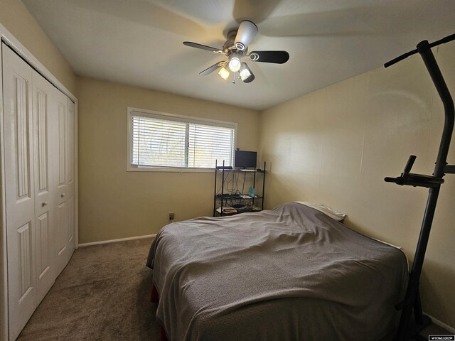 carpeted bedroom featuring baseboards, ceiling fan, and a closet