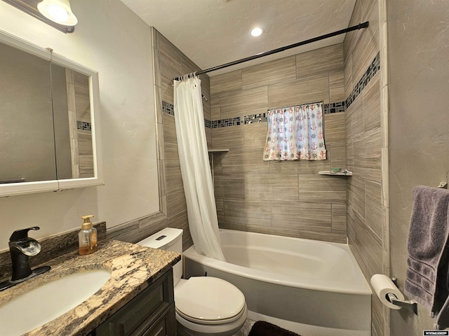 bathroom with vanity, shower / bath combo, and toilet