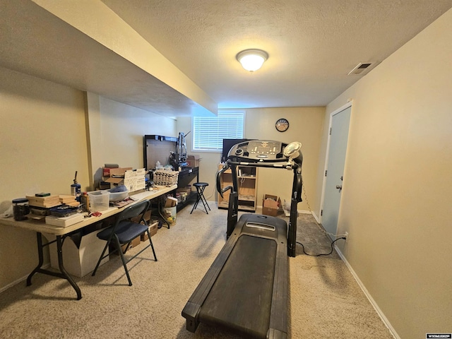 workout area with baseboards, carpet, a textured ceiling, and visible vents