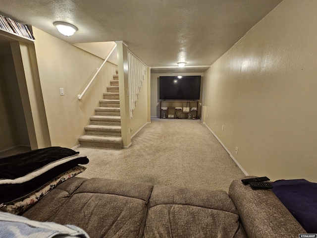 carpeted living room with stairs, a textured ceiling, and baseboards