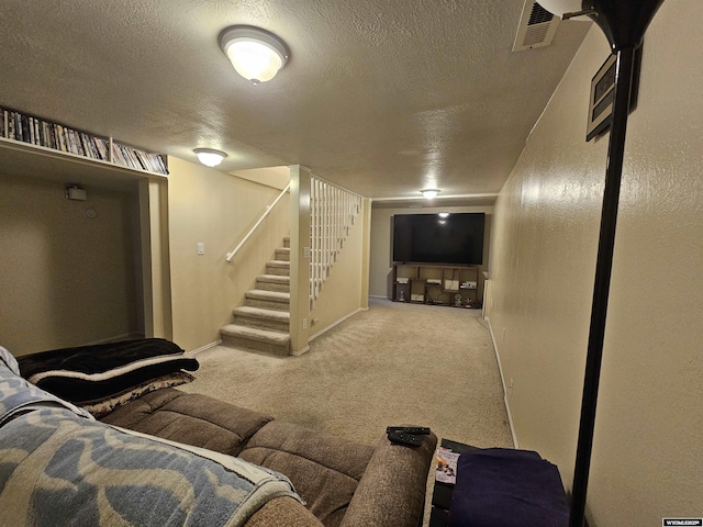 interior space featuring stairway, carpet, a textured ceiling, and visible vents