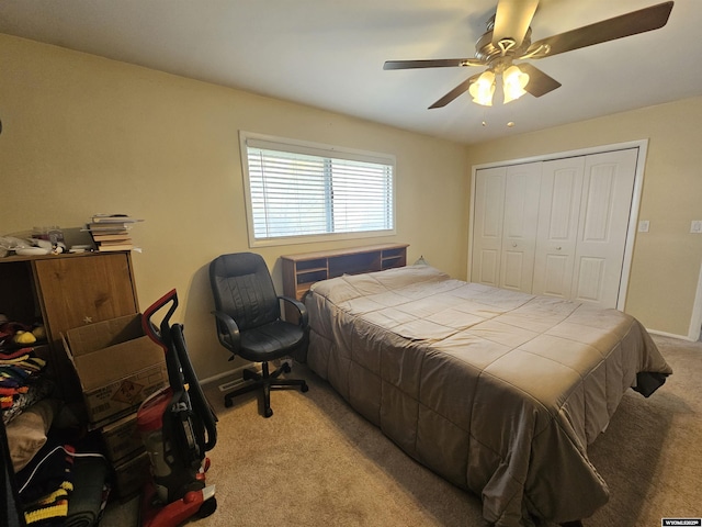 bedroom featuring a ceiling fan, baseboards, light carpet, and a closet
