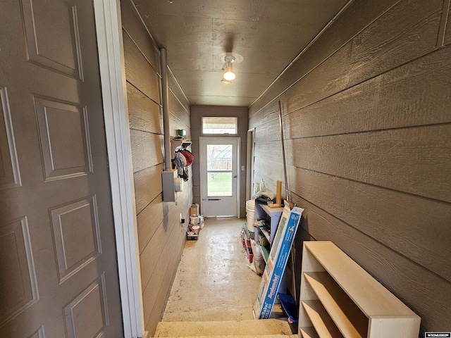 mudroom with wooden walls