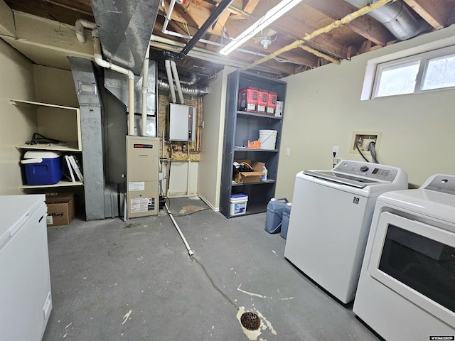 basement featuring fridge and washer and dryer