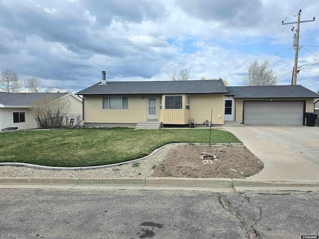 ranch-style house with entry steps, concrete driveway, a front yard, and a garage