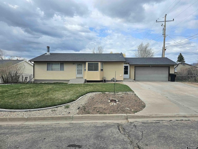 ranch-style house featuring a garage, entry steps, driveway, and a front yard