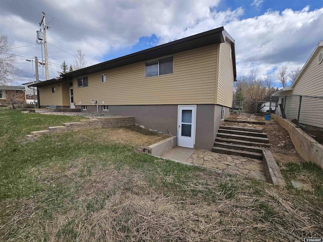 back of house with a yard and stairway