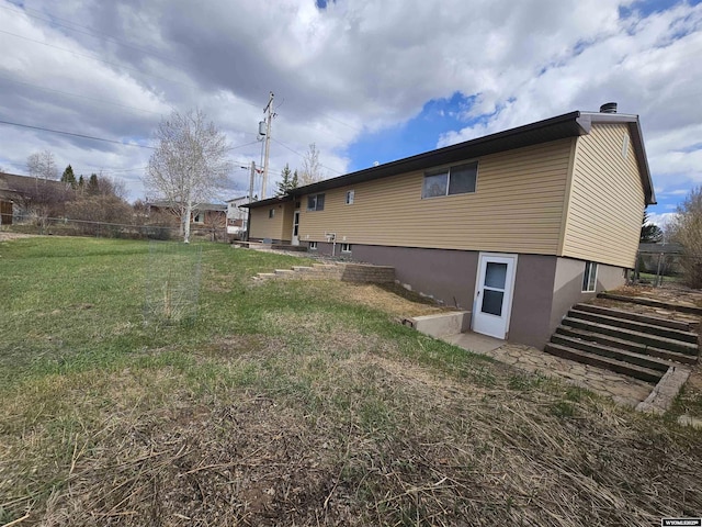 view of side of property with a lawn