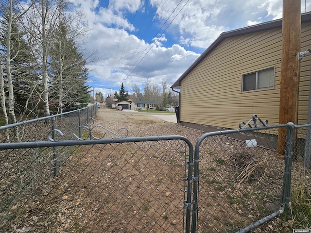view of yard with fence and a gate