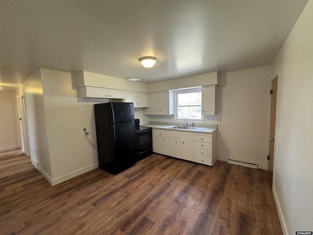 kitchen featuring dark wood-style flooring, a sink, light countertops, white cabinetry, and black appliances