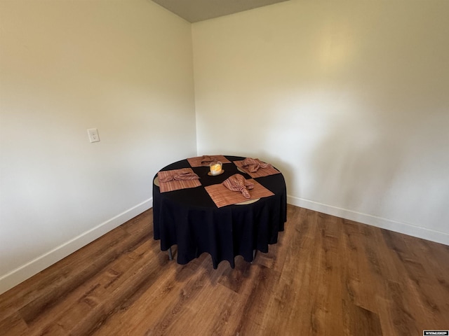 bedroom with baseboards and wood finished floors