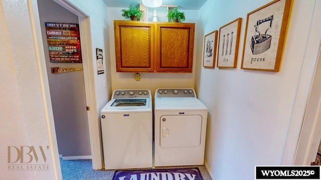 laundry area with separate washer and dryer and cabinet space