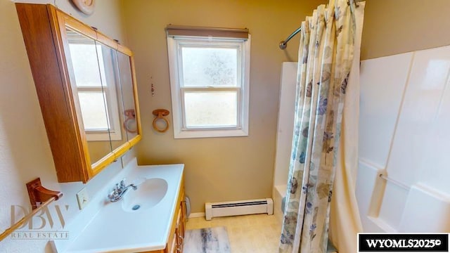 bathroom with vanity, baseboards, baseboard heating, and shower / bath combo