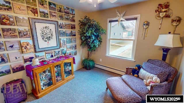 living area with carpet floors, a ceiling fan, and baseboard heating