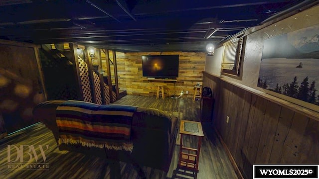 exterior space featuring wood walls, wood finished floors, and stairway