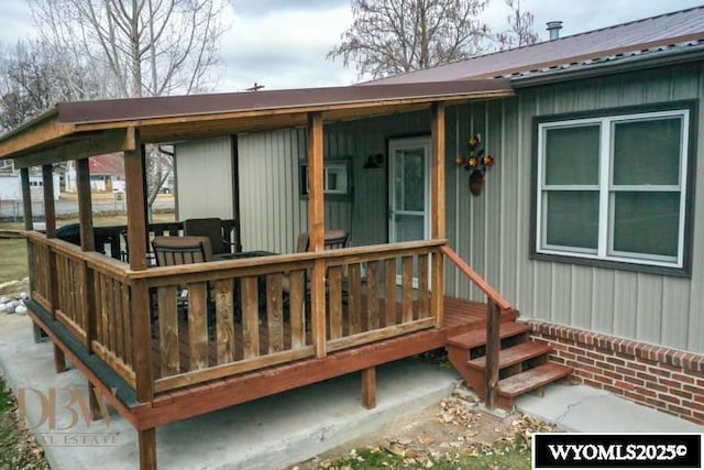 property entrance featuring board and batten siding and metal roof