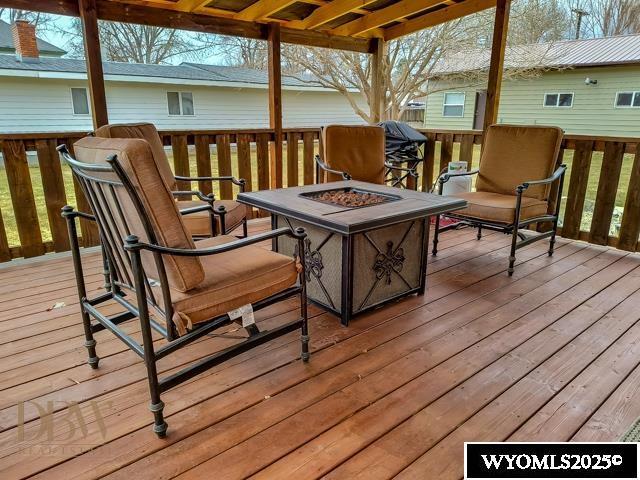 wooden deck with a fire pit