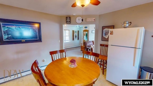 dining room featuring ceiling fan and baseboard heating