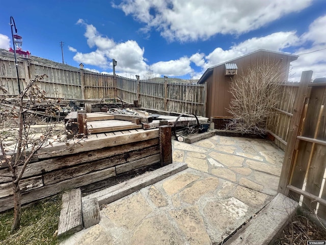 2025 Rolling Hls, Kemmerer, WY 83101 - view of patio / terrace featuring an outdoor structure, a fenced backyard, and a shed