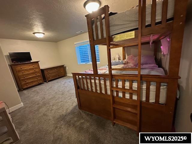 109 Chardonnay, Rock Springs, WY 82901 - carpeted bedroom featuring a textured ceiling, visible vents, and baseboards