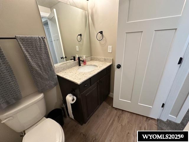 109 Chardonnay, Rock Springs, WY 82901 - bathroom featuring vanity, toilet, and wood finished floors