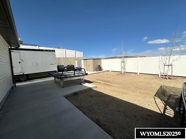 109 Chardonnay, Rock Springs, WY 82901 - view of yard with a fenced backyard, a storage unit, a patio, and an outdoor structure