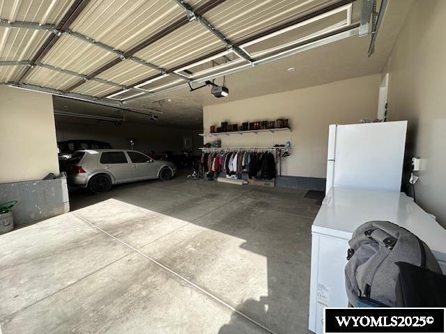 109 Chardonnay, Rock Springs, WY 82901 - garage featuring freestanding refrigerator and a garage door opener
