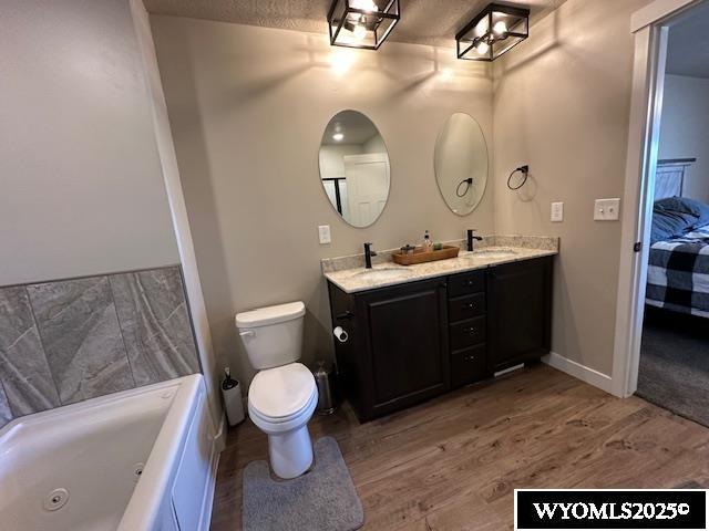 109 Chardonnay, Rock Springs, WY 82901 - full bath with wood finished floors, toilet, ensuite bathroom, a whirlpool tub, and a sink