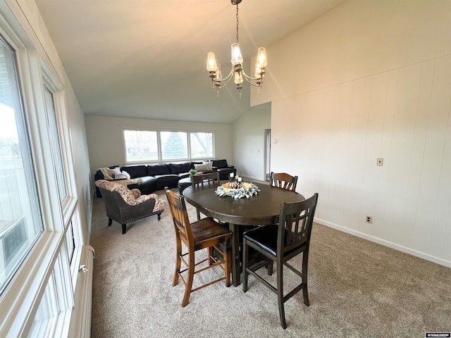 dining room with a chandelier and carpet