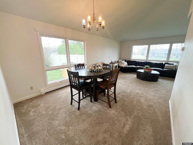 carpeted dining room featuring an inviting chandelier, a baseboard radiator, and baseboards