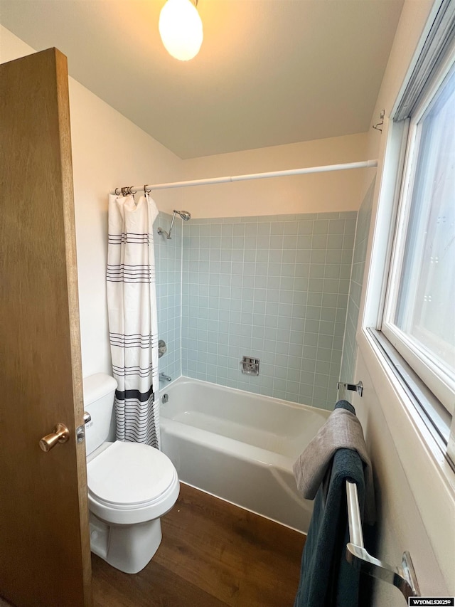 bathroom with toilet, shower / bath combination with curtain, and wood finished floors