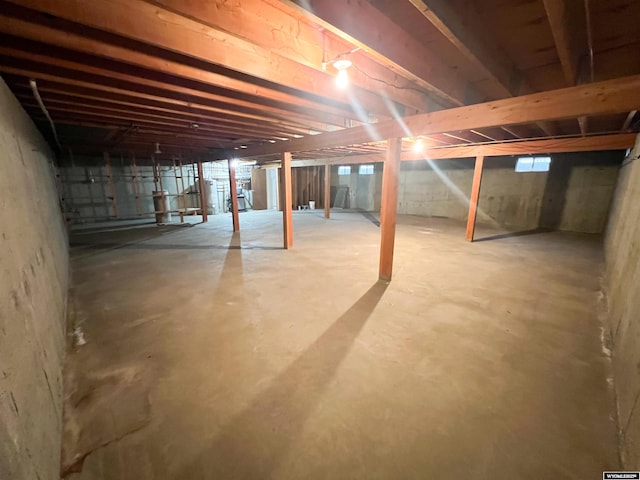 unfinished basement featuring gas water heater