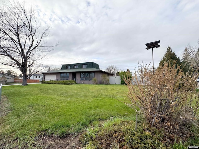 view of yard with a garage and fence