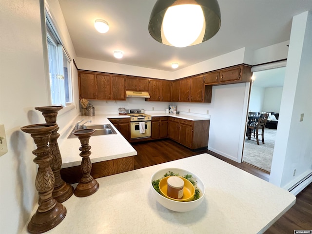 kitchen featuring dark wood-style flooring, white electric range oven, a sink, light countertops, and under cabinet range hood