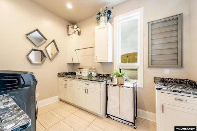 88 Turnberry Dr, Sheridan, WY 82801 - kitchen with white cabinets, dark stone countertops, recessed lighting, baseboards, and light tile patterned floors