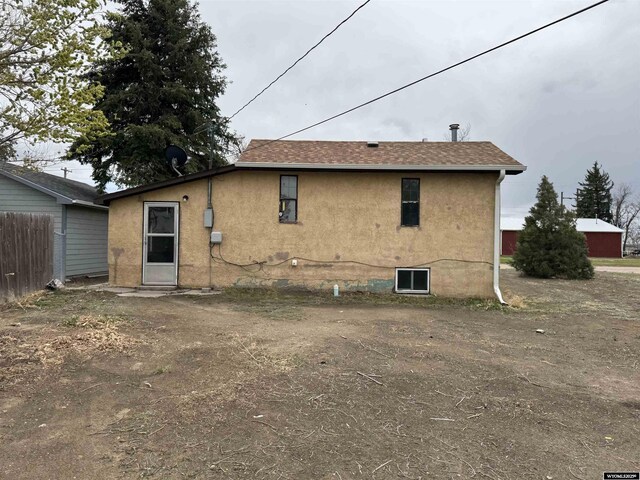 124 Railroad St, Lingle, WY 82223 - back of property featuring fence and stucco siding