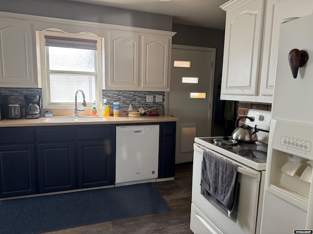 kitchen with white appliances, a sink, and tasteful backsplash