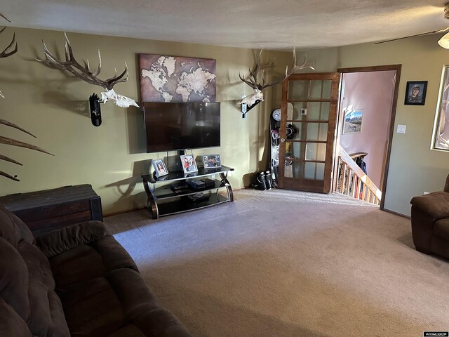 carpeted living area with baseboards