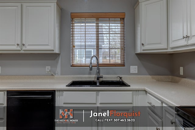kitchen with plenty of natural light, a sink, white cabinets, and black appliances