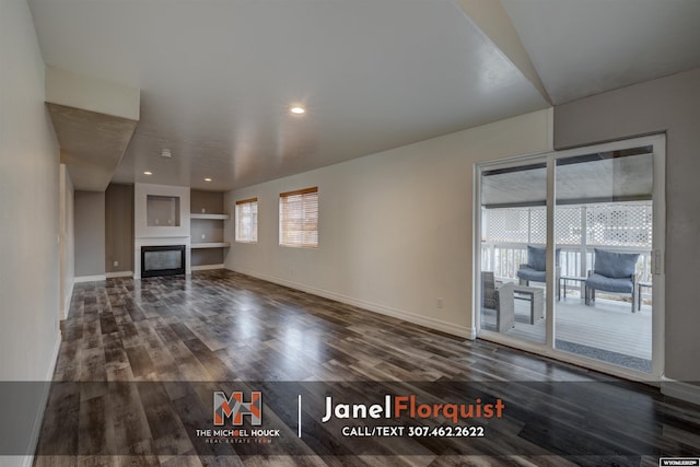 3507 Aspen Ln, Casper, WY 82604 - unfurnished living room with recessed lighting, baseboards, a glass covered fireplace, and dark wood-type flooring
