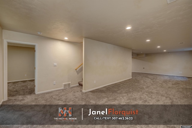 finished below grade area featuring visible vents, stairway, baseboards, carpet flooring, and recessed lighting