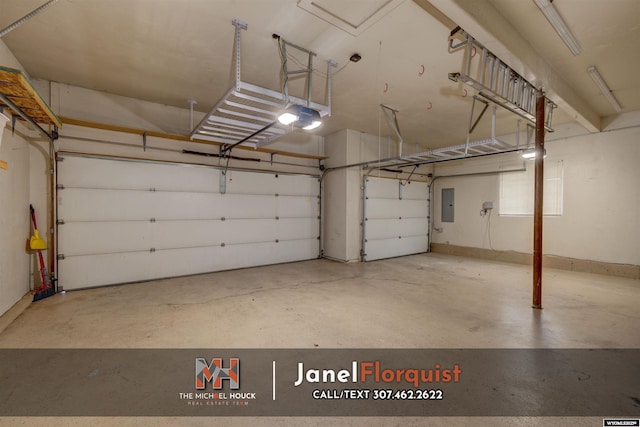 garage with a garage door opener and electric panel