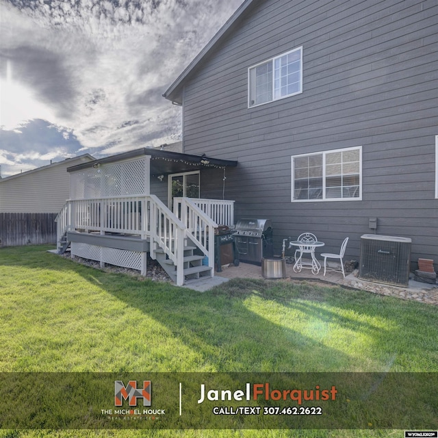 3507 Aspen Ln, Casper, WY 82604 - rear view of property featuring a lawn, fence, cooling unit, and a wooden deck