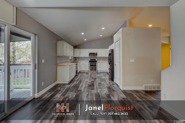 3507 Aspen Ln, Casper, WY 82604 - kitchen featuring visible vents, a healthy amount of sunlight, dark wood-style floors, a sink, and stainless steel appliances