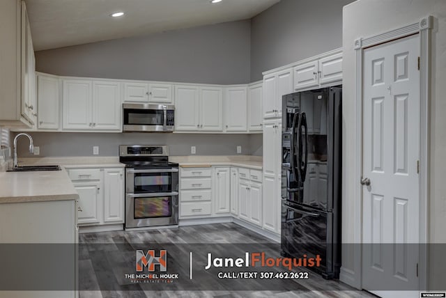 3507 Aspen Ln, Casper, WY 82604 - kitchen with appliances with stainless steel finishes, a sink, light countertops, high vaulted ceiling, and dark wood-type flooring