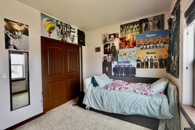 carpeted bedroom with baseboards